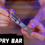 the edc pry bar is being held by a person.