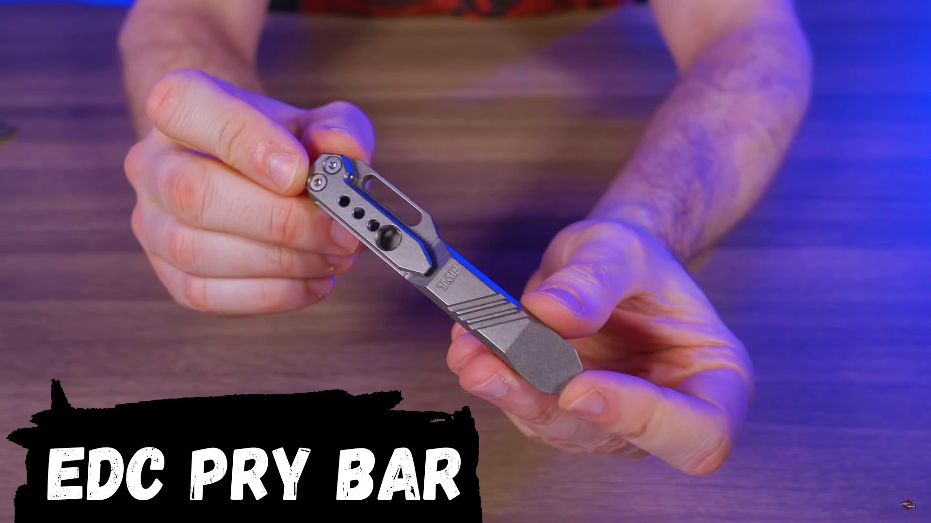 the edc pry bar is being held by a person.
